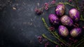 flat lay purple Easter eggs with gold decoration and floral branches on dark background. free space Royalty Free Stock Photo