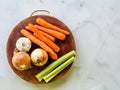 Flat lay of raw vegetables mirepox ingredients Ã¢â¬â onions, celery and carrots with copy space