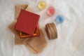 Flat lay of red gift and three colorful candles. Red gift box. Burlap sack Royalty Free Stock Photo