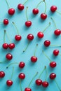 Flat lay red ripe cherry berries on turquoise background. Top view Royalty Free Stock Photo