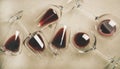 Flat-lay of red wine in glasses over grey concrete background Royalty Free Stock Photo