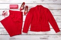 Flat lay red women suit and accessories. Royalty Free Stock Photo