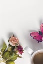 Flat lay of rose flower , butterfly and a cup of coffee on white background Royalty Free Stock Photo