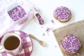Dutch breakfast with rusk and pink purple hail, cup of tea, on white table
