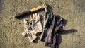 Flat lay of rusty metal hammer and construction white hand glove on grunge cement background