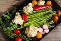 Salad of fresh vegetables on black plate over wooden background, close up Royalty Free Stock Photo