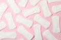 Flat lay with sanitary pads on pink background