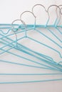 Flat lay set of blue hangers on white marble. Many colored hangers lying chaotically, minimal concept Royalty Free Stock Photo