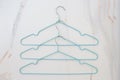 Flat lay set of blue hangers on white marble. Many colored hangers lying chaotically, minimal concept Royalty Free Stock Photo