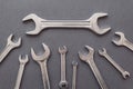 Flat lay of set of spanners and wrench on blue grey background. Repairing tools Royalty Free Stock Photo