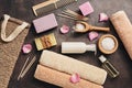 Flat lay a set of various bath accessories. Terry towel, soap, comb, oil, shampoo, loofah washcloth, sea salt on a dark rustic Royalty Free Stock Photo