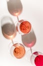 Glasses of white and pink wine with their shadows Royalty Free Stock Photo