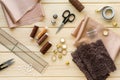 Cloth, threads and tailoring tools on wooden background Royalty Free Stock Photo