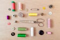 Flat lay of sewing materials: scissors, bobbin, buttons, safety pins, threads. Flat lay, top view