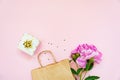 Flat lay of shopping bag, gift box and peony flower over pink background. Copy space Royalty Free Stock Photo