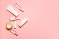 Flat lay shot with a copy space on a pink background with skincare goods: hand cream, deodorant, lipstick, facial serum, essential Royalty Free Stock Photo