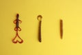 Flat lay shot of different fishing lures on a yellow surface Royalty Free Stock Photo