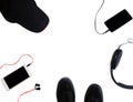 Flat Lay. Smartpnones, Black Sneakers, Cap And Headphones Isolated On White Background. Sport Objects In Circle. Copy Space