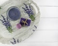 Flat lay spa bath on white wooden background, top view cosmetic products. Bomb, soap and candle lavender