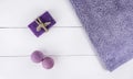 Flat lay spa bath on white wooden background, top view products for hygiene. Bombs and soap from lavender with towel