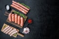 Raw sausages, flat lay with space for text, on black background