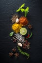 Flat-lay of spices and herbs on black background. Ingredients for cooking. Food background on stone. Top view copy space Royalty Free Stock Photo