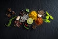 Flat-lay of spices and herbs on black background. Ingredients for cooking. Food background on stone. Top view copy space Royalty Free Stock Photo