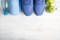Flat lay sport shoes, bottle of water, apples, towel and earphones on white background. Sport equipment. Healthy lifestyle, sport Royalty Free Stock Photo