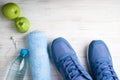 Flat lay sport shoes, bottle of water, apples, towel and earphones on white background. Sport equipment. Healthy lifestyle, sport Royalty Free Stock Photo
