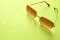 Flat lay  Square sunglasses isolate on a green background Royalty Free Stock Photo