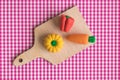 Flat lay of squash, pepper and carrot on cutting board abstract against red classic checkered tablecloth texture. Royalty Free Stock Photo