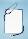 Flat lay of stethoscope and writing pad paper clip board on light blue background with copy space, healthcare and medical concept Royalty Free Stock Photo