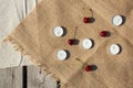 Flat lay, still life and food photo. Cherry berries and candles lie on a burlap on a wooden floor Royalty Free Stock Photo