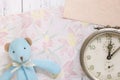 Flat lay stock photography flower pattern message letter paper blue bear doll antique alarm clock