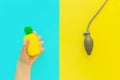 Flat lay stress, antistress: toy squish yellow pineapple in hand, blood pressure monitor.Bright blue background.Compressing, soft,