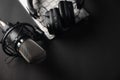 Flat lay, Studio microphone with professional headphones on a PC keyboard. Black on a black background. Podcasts, radio, streams, Royalty Free Stock Photo