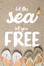 flat lay with summer flip flops and seashell on sand, let sea set you free inscription Royalty Free Stock Photo