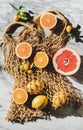 Flat-lay of summer net bag with fresh ripe citrus fruits