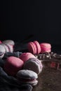 Flat-lay of sweet pink, violet french macaroon cookies on black slate plate Royalty Free Stock Photo