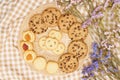 Flat lay of sweets, Butter cookie and chocolate chip cookie in rattan plate on brown gingham cloth
