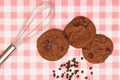 Flat lay of sweets, Chocolate brownie cookie and chocolate chip pieces on red gingham cloth Royalty Free Stock Photo