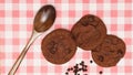 Flat lay of sweets, Chocolate brownie cookie and chocolate chip pieces on red gingham cloth Royalty Free Stock Photo