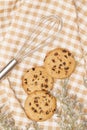 Flat lay of sweets, Chocolate chip cookies and confectionery equipment on brown gingham cloth