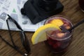 Flat lay of a table with a glass of sangria, a map and a camera Royalty Free Stock Photo