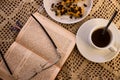 Table with glasses and a book next to a coffee with pastries Royalty Free Stock Photo