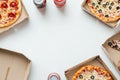 A flat lay of takeaway pizza boxes and soda cans arranged on a clean Royalty Free Stock Photo