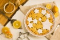 Flat lay tart with lemon, orange and ginger jam decorated with star-shaped cookies