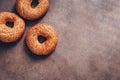 Flat lay three bagels with sesame on a dark rustic background. Top view, copy space Royalty Free Stock Photo