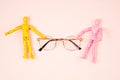Flat lay with to maniquins holding eye glasses. Eye vision check concept