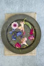 Flat lay top down view image of romantic vintage look of Spring and Summer flower petals and blooms still life on rustic old worn